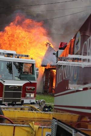 Fire Trucks On A Fire Scene With Flames